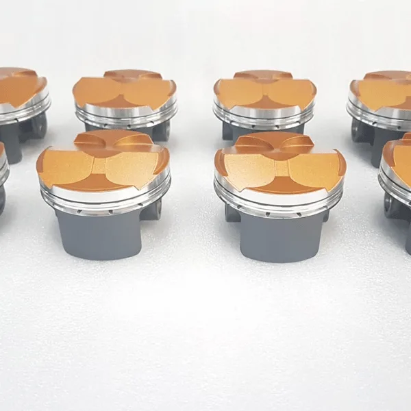 Gold ceramic coated piston crowns